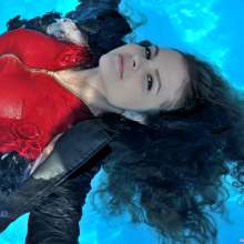 ufa217: Vanessa in a red dress swims in the pool.