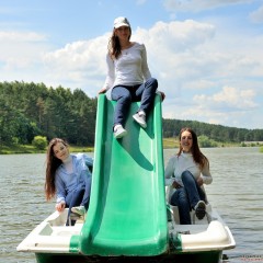 ufa217: Three girlfriends are having fun on a catamaran, fully clothed.