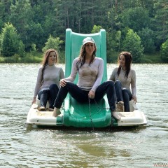 ufa217: Three girlfriends are having fun on a catamaran, fully clothed.