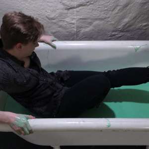 Stella: Stella bathes in a tub filled with 30 gallons of green gunge.