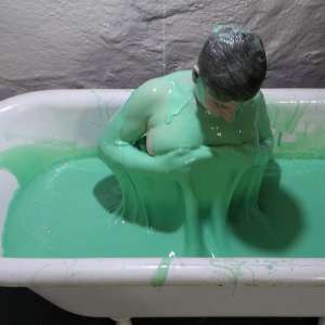 Stella: Stella bathes in a tub filled with 30 gallons of green gunge.
