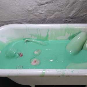Stella: Stella bathes in a tub filled with 30 gallons of green gunge.