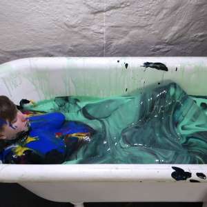 Stella: Stella paints her naked body in tub full of gunge.