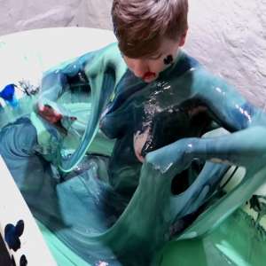 Stella: Stella paints her naked body in tub full of gunge.