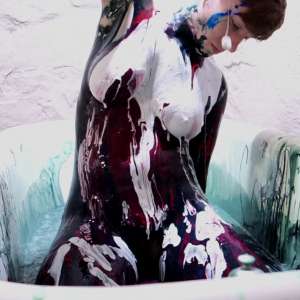 Stella: Stella paints her naked body in tub full of gunge.