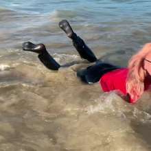 Wet_look_elena: Black Latex Pants and Red Top in the Sea