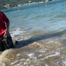 Wet_look_elena: Black Latex Pants and Red Top in the Sea