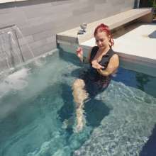 WetlookFashion: Scarlett Has a Smoke in the Hot Tub While Fully-Clothed